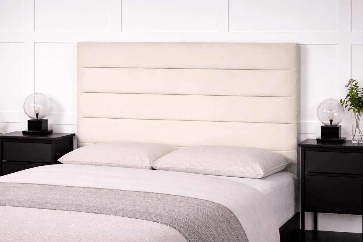 Bedroom with a bed featuring a beige upholstered headboard, white bedding, and black nightstands.